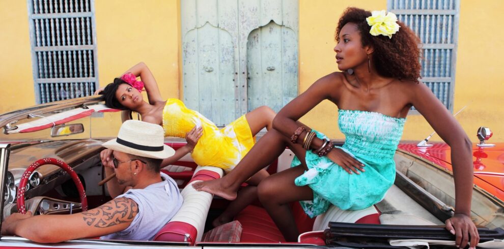 Beautiful women posing in an antique car in Trinidad, Cuba